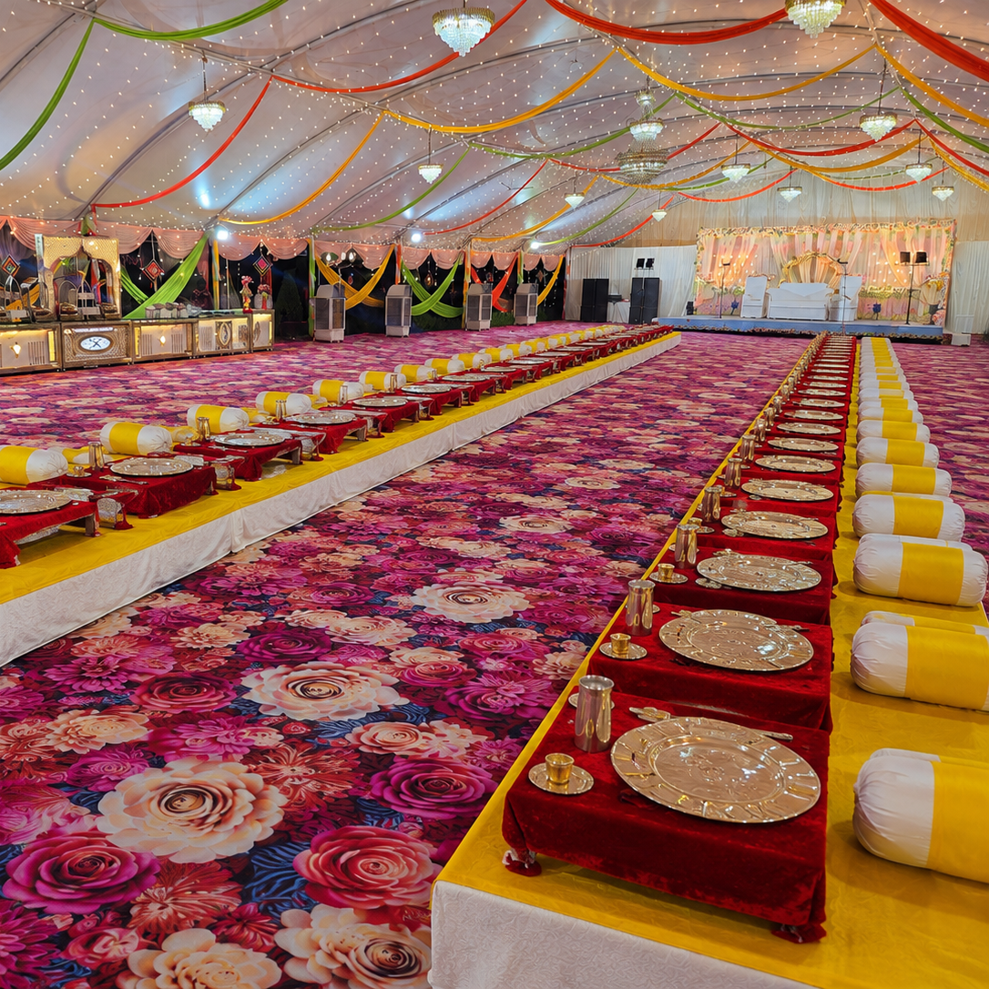 Premium Wedding Buffet Setup in Bhopal Traditional wedding dining setup with floral carpet, silver thali service and royal takhat seating at Utsav Marriage Garden, Bhopal.